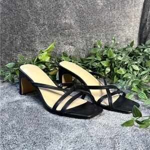 Woman’s black strappy heels